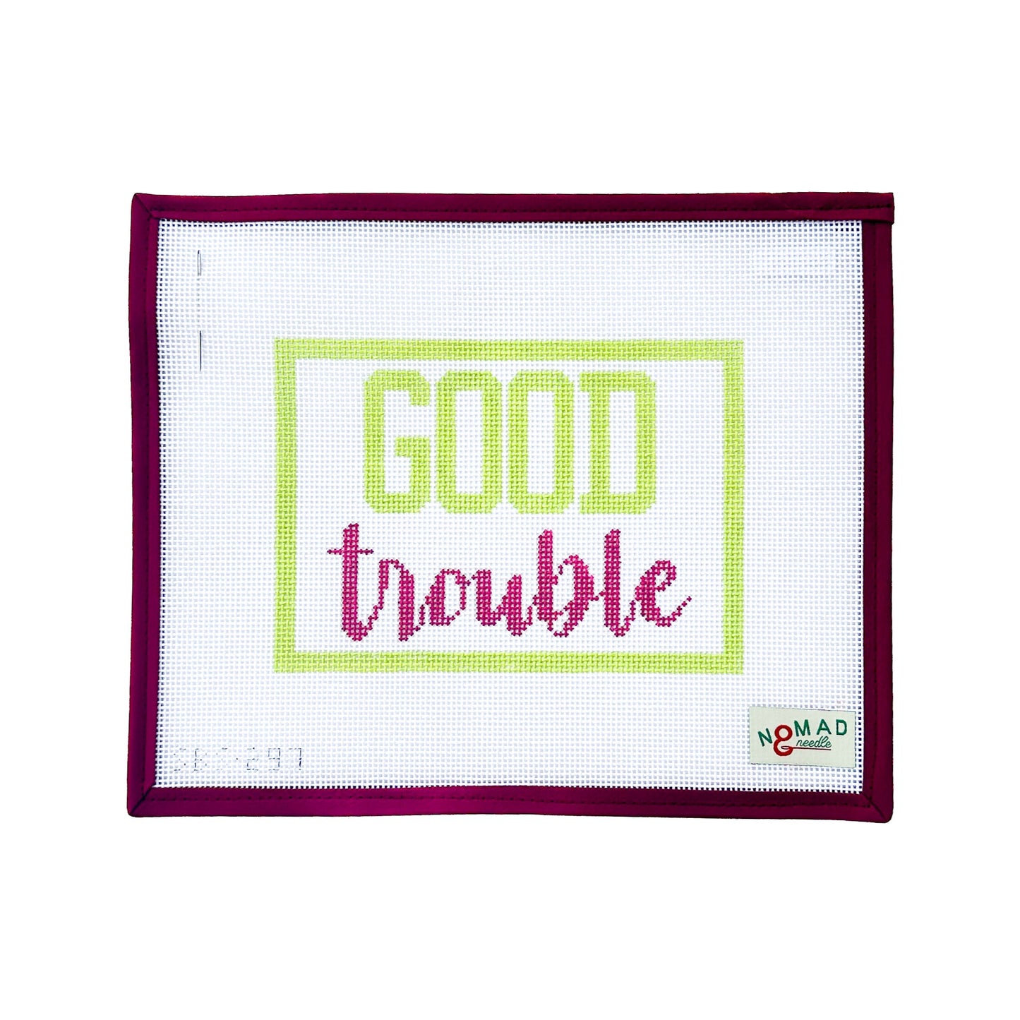 Hand-painted needlepoint canvas with the phrase “Good Trouble” in bold lime green and magenta script, inspired by civil rights leader John Lewis. Designed by Nomad & Needle.