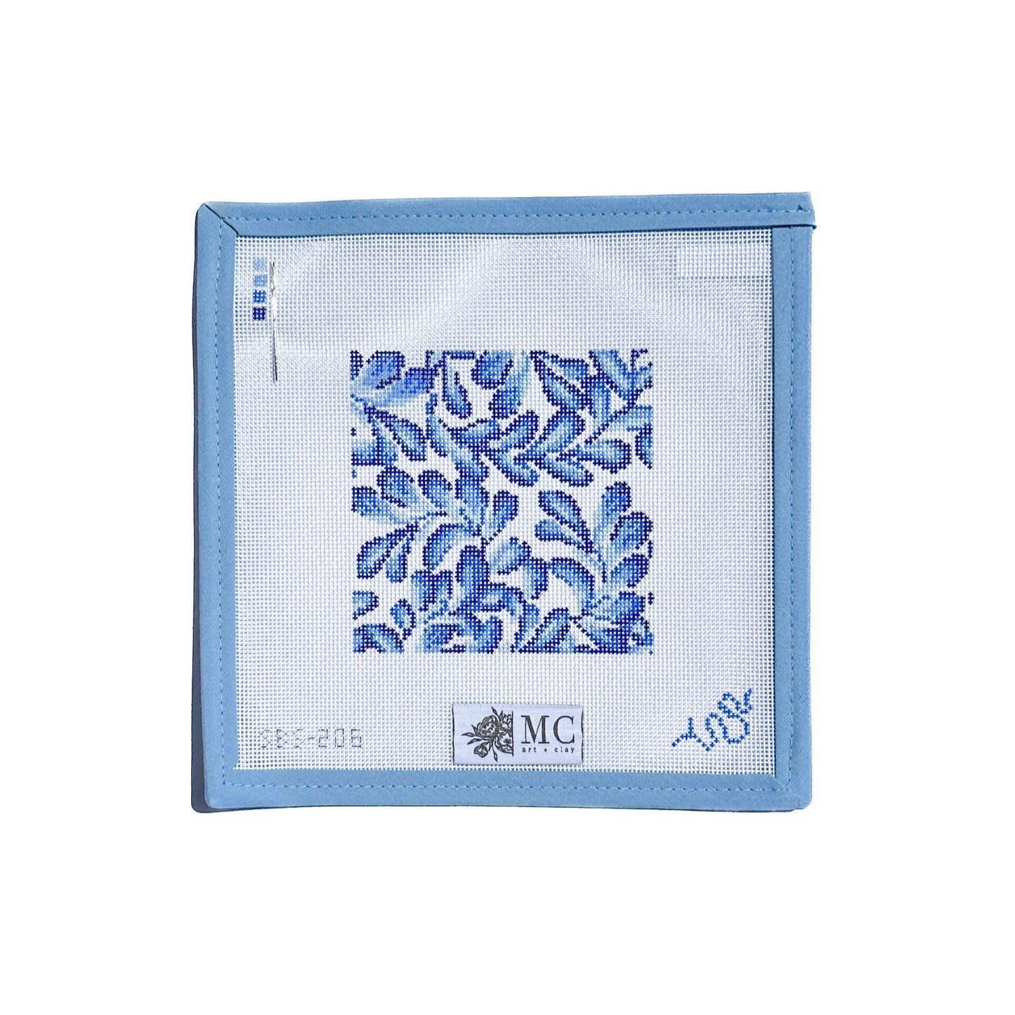 needlepoint canvas square with floral pattern on a white background