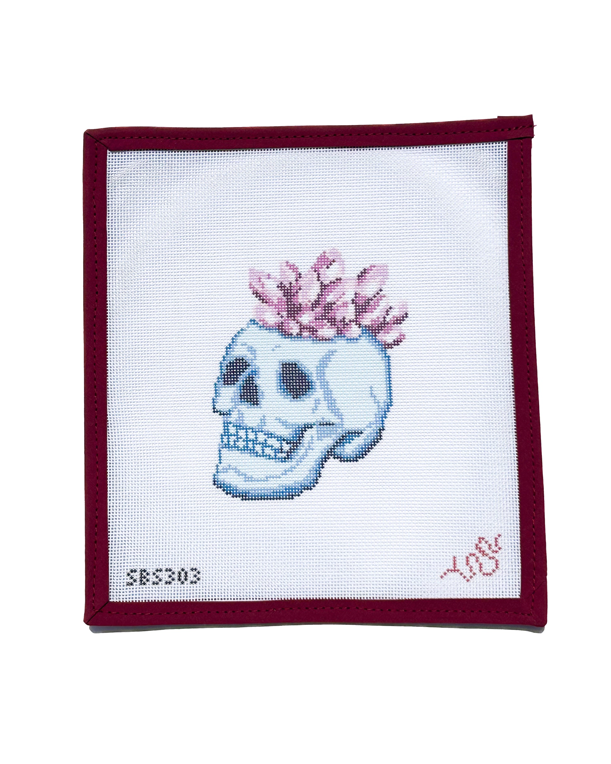 Needlepoint canvas featuring a detailed blue skull topped with pink crystal crown, a modern and edgy design by Spellbound Stitchery.