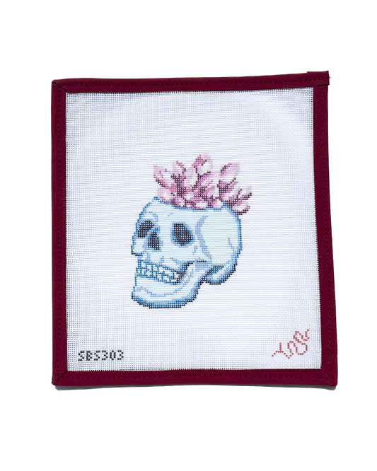 Needlepoint canvas featuring a detailed blue skull topped with pink crystal crown, a modern and edgy design by Spellbound Stitchery.
