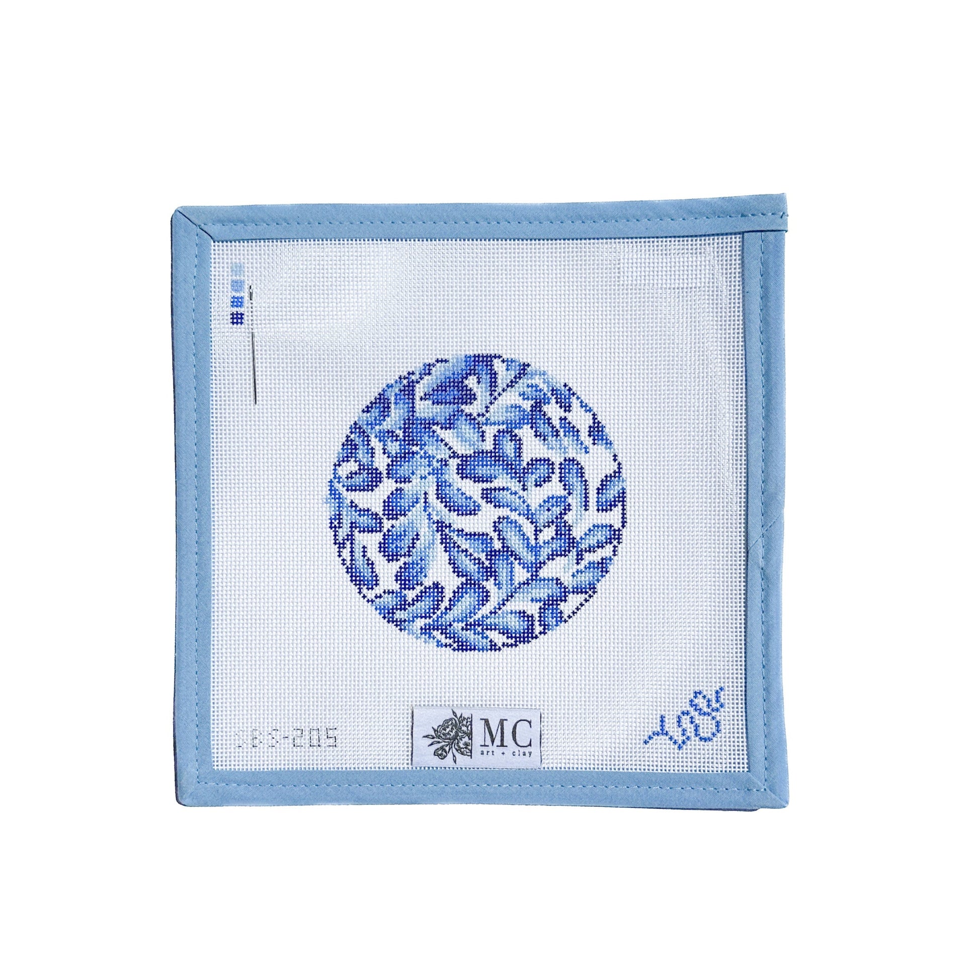 Blue and white patterned needlepoint canvas on a white background
