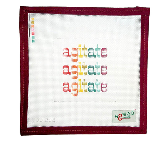 Hand-painted needlepoint canvas featuring the word “agitate” stitched three times in bright, bold colors, inspired by a quote from Frederick Douglass. Designed by Nomad & Needle.