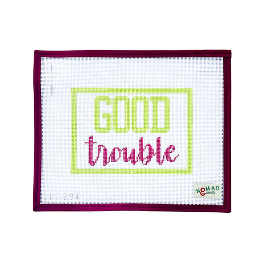 Hand-painted needlepoint canvas with the phrase “Good Trouble” in bold lime green and magenta script, inspired by civil rights leader John Lewis. Designed by Nomad & Needle.