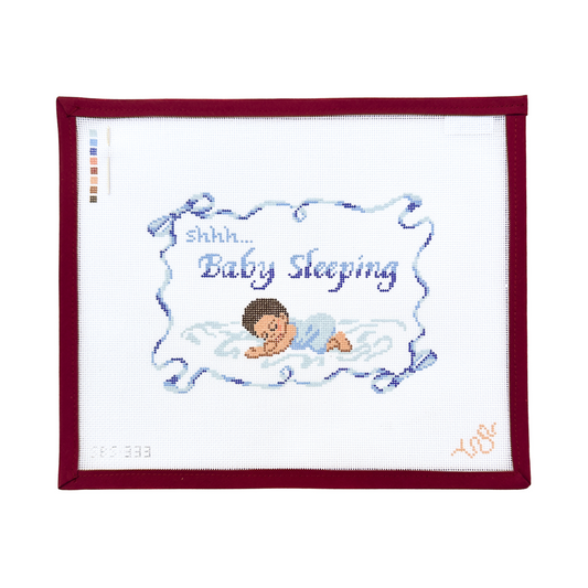 needlepoint canvas with a baby sleeping design
