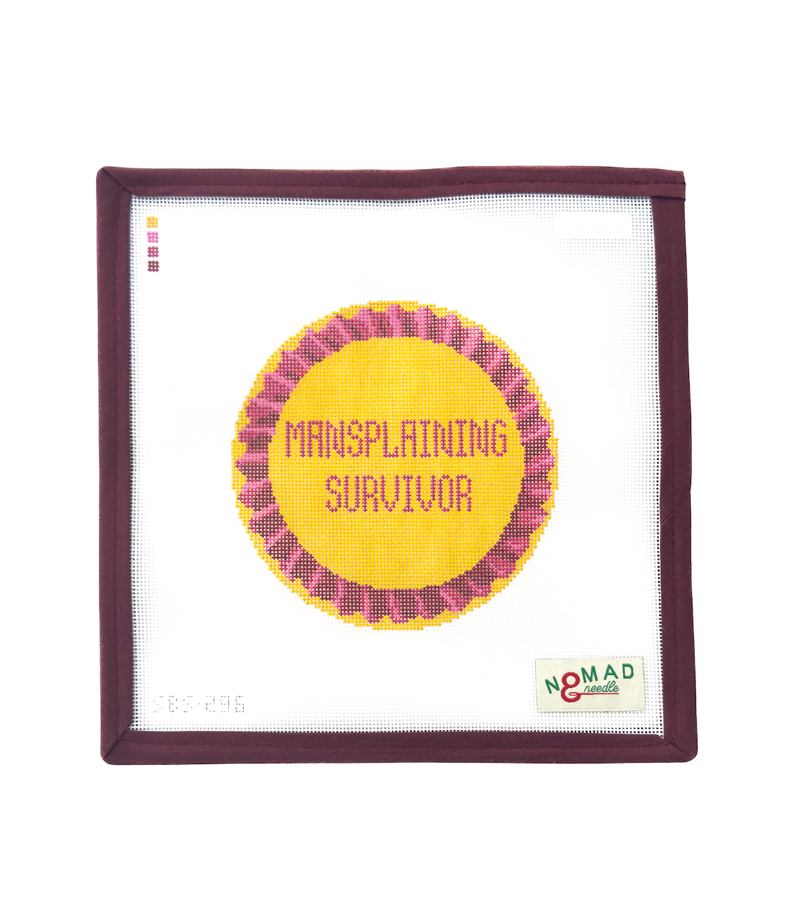 Hand-painted needlepoint canvas featuring a bold yellow and pink ribbon that reads “Mansplaining Survivor,” designed by Nomad & Needle for feminist stitching.