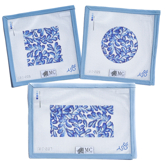 Set of three blue floral patterned needlepoint canvases with 'MC' branding on a white background